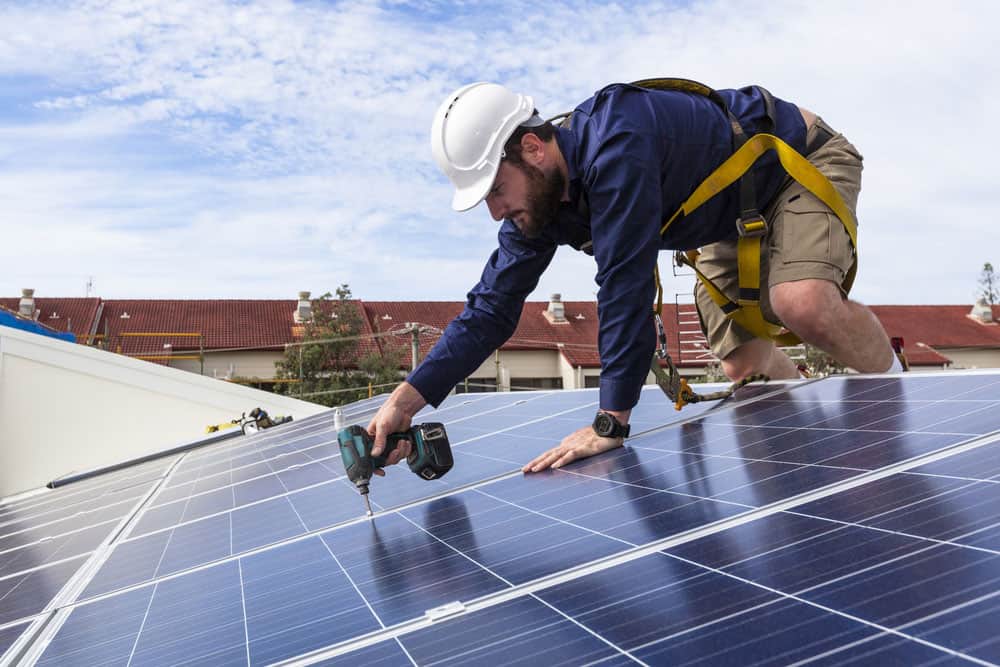 A tech installing solar panels